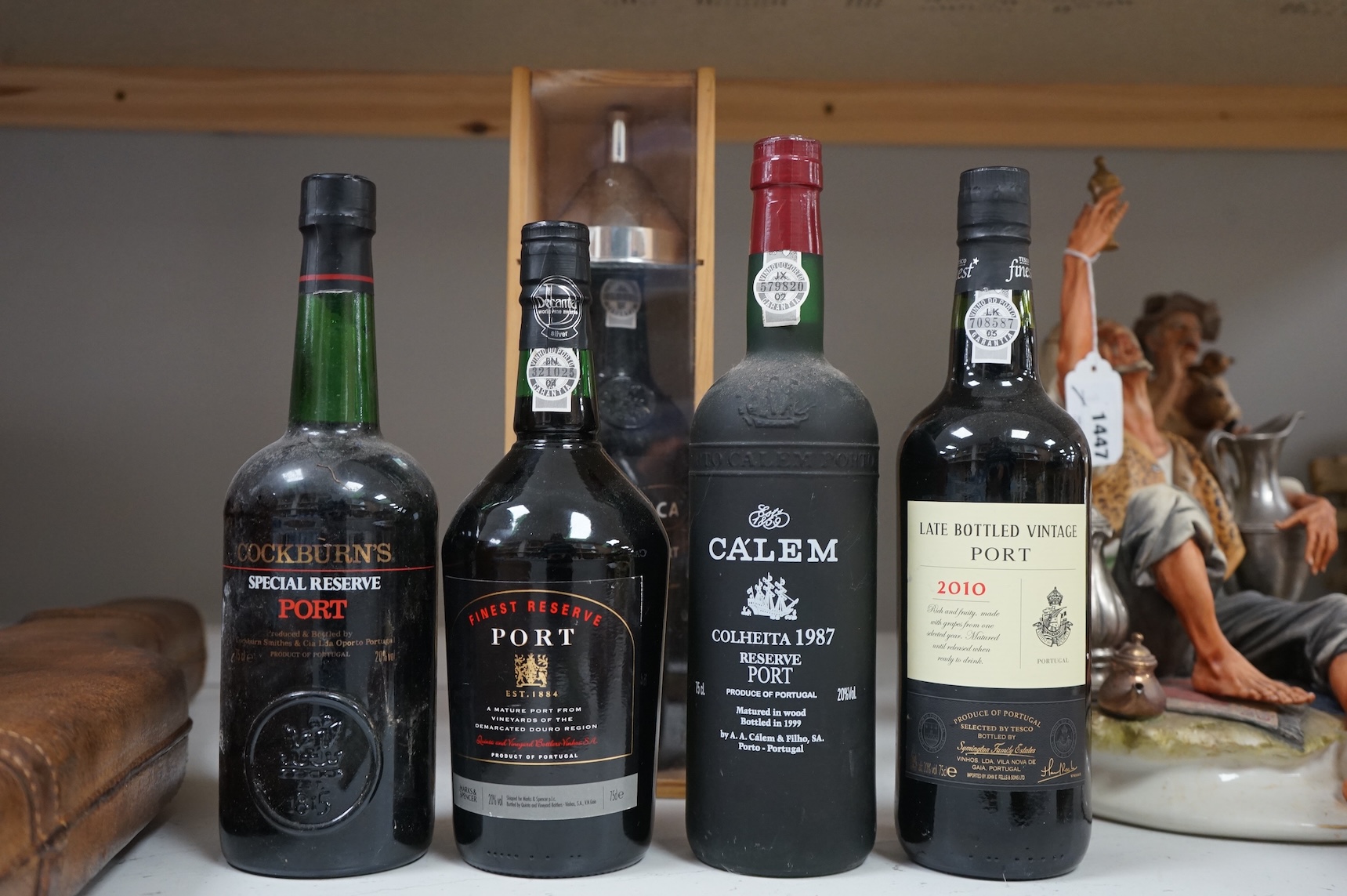 Five assorted bottles of port, including a boxed Fonseca 1988, a bottle of Calem 1987 and three other bottles of port.